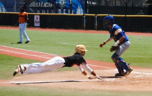 Campbell's Nick Sampson slid in safely to score the Sabers' first run in the second inning. Photo by Jerry Campany/Star-Advertiser.