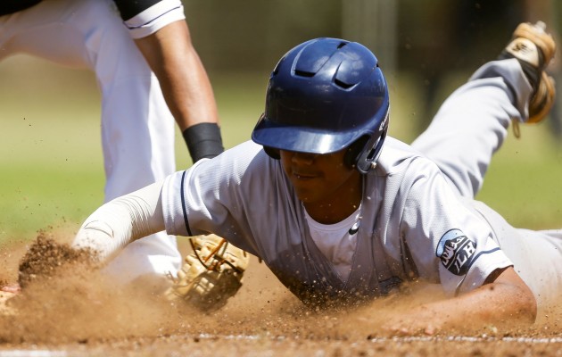 St. Francis pitcher James Yamasaki dove into first base during the third inning of Saturday's game against Damien. Photo by Matt Hirata/Special to the Star-Advertiser.