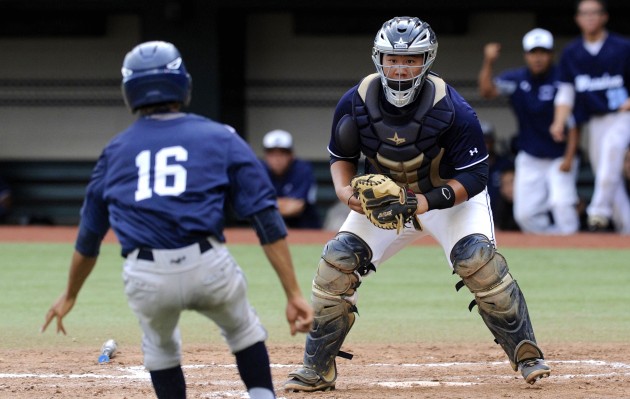 Waiakea's Curren Inouye was waiting at home plate to tag out Kamehameha's Francis Gora who tried to score from second on an infield single. Photo by Bruce Asato/Star-Advertiser.