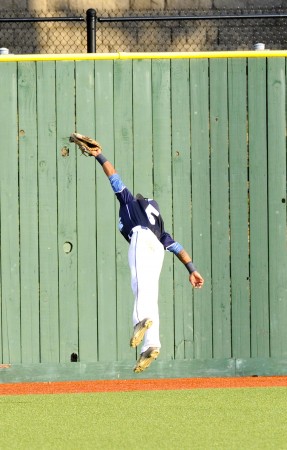 Waiakea's Gehrig Octavio made a leaping over-the-shoulder catch to preserve the Warriors' 2-0 win over Kamehameha in the state semifinals. Photo by Bruce Asato/Star-Advertiser.